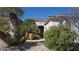 Landscaped front entrance featuring desert plants and stone walkway at 5059 Pensier St, Las Vegas, NV 89135