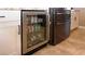 Close up of a modern beverage cooler and stainless steel refrigerator in a custom kitchen at 5059 Pensier St, Las Vegas, NV 89135