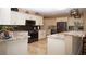 Modern kitchen with stainless steel appliances, granite countertops, and ample cabinet space at 5059 Pensier St, Las Vegas, NV 89135