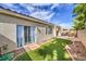 Charming backyard featuring artificial grass, rock accents, and a covered patio, ideal for outdoor relaxation and entertaining at 5078 Shadow River St, Las Vegas, NV 89148