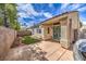 Inviting backyard featuring a stamped concrete patio and a well-maintained lawn area with secure fencing and a nice door to the house at 5078 Shadow River St, Las Vegas, NV 89148