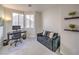 Cozy bedroom featuring a pull out couch, desk, and sunny windows at 5078 Shadow River St, Las Vegas, NV 89148