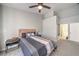 Bedroom featuring modern decor, a large window, and a ceiling fan at 5078 Shadow River St, Las Vegas, NV 89148