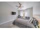 Well-lit bedroom with a ceiling fan, large windows, and a workspace at 5078 Shadow River St, Las Vegas, NV 89148