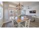 Bright dining area with wood table set, pendant lighting, and sliding glass doors to the backyard at 5078 Shadow River St, Las Vegas, NV 89148