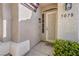 Close-up of front entrance showcasing stucco siding, decorative security door, and welcome mat at 5078 Shadow River St, Las Vegas, NV 89148