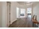 Bright and airy hallway with hardwood flooring and views into the living room at 5078 Shadow River St, Las Vegas, NV 89148