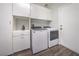 Functional laundry room with modern washer and dryer, built-in storage, and easy outdoor access at 5078 Shadow River St, Las Vegas, NV 89148