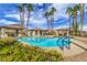 Community pool featuring palm trees, a spa, and lounge chairs for residents, creating a resort-like atmosphere and relaxation at 5078 Shadow River St, Las Vegas, NV 89148