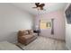 Cozy bedroom with a ceiling fan, wood-look tile flooring, and a loveseat for relaxing at 5081 Monte Penne Way # 2, Pahrump, NV 89061