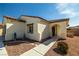 Charming single-story home with a tiled roof, arched entry, and landscaped front yard with desert plants at 5081 Monte Penne Way, Pahrump, NV 89061