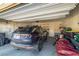 Organized garage featuring a blue SUV, storage shelves, and various containers for tools and equipment at 5081 Monte Penne Way # 2, Pahrump, NV 89061