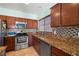 Modern kitchen with stainless steel appliances, granite countertops, tile backsplash, and ample cabinetry at 5081 Monte Penne Way, Pahrump, NV 89061