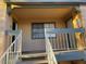 Condominium exterior entrance with stairs, two doors, neutral paint, and a cozy balcony at 5130 S Jones Blvd # 203, Las Vegas, NV 89118