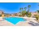 A community pool glistens in the sun surrounded by palm trees and resort-style condos at 5130 S Jones Blvd # 203, Las Vegas, NV 89118