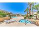 Relaxing outdoor area with a pool, spa, lounge chair, palm trees, and well-maintained landscaping at 5130 S Jones Blvd # 203, Las Vegas, NV 89118