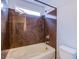 A bathtub with brown-marbled wall, a window and a toilet are featured in this bathroom at 5186 Bootlegger Ave, Las Vegas, NV 89141