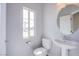 Well-lit half bathroom features pedestal sink and modern fixtures, offering a convenient space for guests at 5186 Bootlegger Ave, Las Vegas, NV 89141