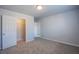 Bedroom with carpet, neutral walls and a double-door closet offers a glimpse of other rooms at 5186 Bootlegger Ave, Las Vegas, NV 89141