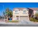 Two-story home featuring a terra cotta-colored roof, neutral-colored siding, and a two-car garage at 5186 Bootlegger Ave, Las Vegas, NV 89141