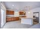 Kitchen with brown cabinetry, stainless steel appliances, and large granite island at 5186 Bootlegger Ave, Las Vegas, NV 89141