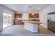 Kitchen featuring stainless steel appliances, wooden cabinets, and a granite-topped island at 5186 Bootlegger Ave, Las Vegas, NV 89141