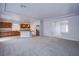 Open-concept living space with neutral-colored walls and carpet leading into the kitchen at 5186 Bootlegger Ave, Las Vegas, NV 89141