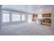 Living space with multiple windows and sliding glass door, opening into kitchen with island at 5186 Bootlegger Ave, Las Vegas, NV 89141