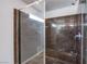 Luxurious shower with marble-look tile and glass enclosure, offering a spa-like experience at 5186 Bootlegger Ave, Las Vegas, NV 89141