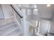 Bright staircase boasts neutral carpet, white walls, and modern glass and metal railings at 5186 Bootlegger Ave, Las Vegas, NV 89141