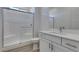 Modern bathroom with a glass-enclosed shower, sleek vanity, and wood-look tile flooring at 522 Riley Ridge Ct, Henderson, NV 89012