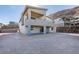 Modern two-story home with patio, balconies and a rock wall landscape feature at 522 Riley Ridge Ct, Henderson, NV 89012