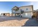 The modern home features a covered balcony and large yard with rock wall at 522 Riley Ridge Ct, Henderson, NV 89012