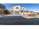 Contemporary two-story home with stone accents, three-car garage, and landscaped front yard at 522 Riley Ridge Ct, Henderson, NV 89012