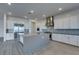 Open-concept kitchen with a gray island, stainless steel appliances, and modern white cabinetry at 522 Riley Ridge Ct, Henderson, NV 89012