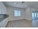 Bright kitchen featuring stylish cabinetry, stainless steel appliances, backsplash, and sliding glass doors to patio at 522 Riley Ridge Ct, Henderson, NV 89012