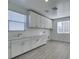 Spacious laundry room featuring a sink, countertops, ample cabinet space, and natural light at 522 Riley Ridge Ct, Henderson, NV 89012