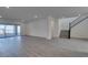 Expansive living room with tile flooring, sliding glass doors, and adjacent staircase at 522 Riley Ridge Ct, Henderson, NV 89012