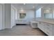 Contemporary bathroom with dual vanities, a soaking tub, and wood-look floors at 522 Riley Ridge Ct, Henderson, NV 89012