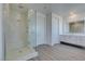 Bright bathroom featuring a glass shower with a bench seat and dual vanities at 522 Riley Ridge Ct, Henderson, NV 89012