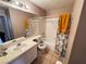 Cozy bathroom with a shower-tub combo and a single sink vanity featuring a neutral color palette at 5513 Oakwood Ridge St, Las Vegas, NV 89130