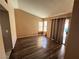 Bedroom with wood-look flooring, neutral walls, window with blinds, and sliding door access at 5513 Oakwood Ridge St, Las Vegas, NV 89130