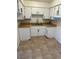 Functional kitchen showcasing white cabinetry, butcher block counters, and tile flooring at 575 S Royal Crest Cir # 18, Las Vegas, NV 89169