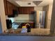 This kitchen is equipped with stainless steel appliances, granite countertops, and dark wood cabinetry at 6800 E Lake Mead Blvd # 1126, Las Vegas, NV 89156