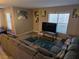 A cozy living room with a comfortable sofa, artwork, and a television at 6800 E Lake Mead Blvd # 1126, Las Vegas, NV 89156