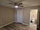 Bedroom with a ceiling fan, vinyl plank flooring, closet, and ensuite bathroom at 6800 E Lake Mead Blvd # 1126, Las Vegas, NV 89156