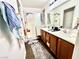 Bright bathroom with double sinks, wood-look tile, and tiled shower at 6819 Mahogany Meadows Ave, Las Vegas, NV 89122