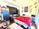 Bedroom featuring a bed, desk, and decorative items against a white wall at 6819 Mahogany Meadows Ave, Las Vegas, NV 89122