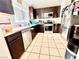 Well-equipped kitchen featuring stainless steel appliances, dark wood cabinetry, and a bright window at 6819 Mahogany Meadows Ave, Las Vegas, NV 89122