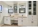 Beautiful bathroom with dual sink vanities, decorative mirrors, and ample cabinet storage at 6925 Donald Nelson Ave, Las Vegas, NV 89131